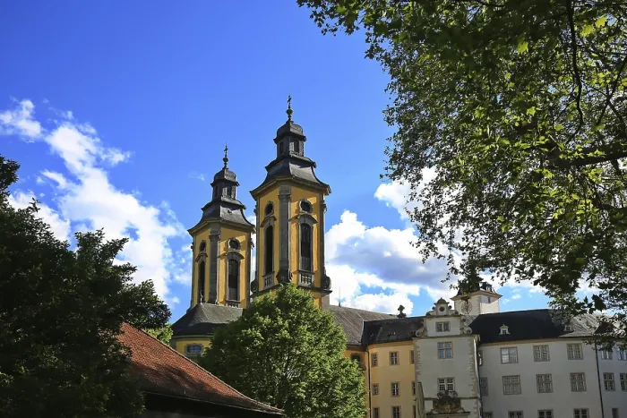 Framed Print : Baroque churches with twin peaks and surrounding trees in historic town