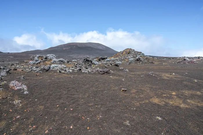 Framed Print : The barren volcanic landscape on the Route du Volcan shows the dark lava soil of the Plaine des Sables