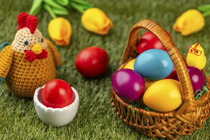 Framed Print : A basket of colorful Easter eggs next to a chicken figurine