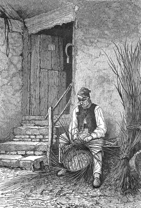 Framed Print : Basket weaver sitting in front of his house weaving a wicker basket