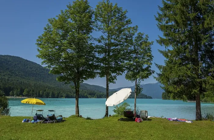 Framed Print : Bathing area with parasols on the shore of Lake Walchensee