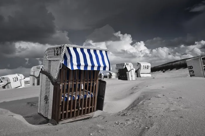 Framed Print : Beach chairs, dramatic clouds in the sky