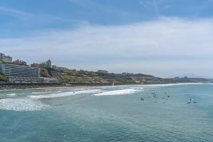 Framed Print : Beach Cote des Basques on a summer afternoon full of surfers
