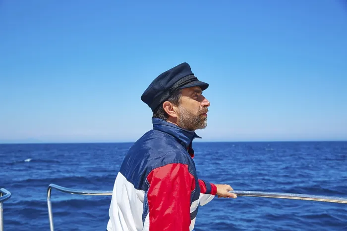 Framed Print : Beard sailor man sailing sea ocean in a boat with captain cap looking horizon