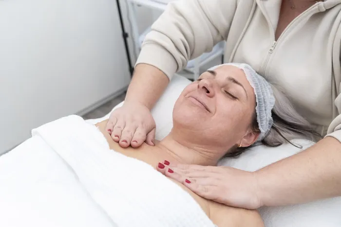 Framed Print : Beautician massaging female client's chest