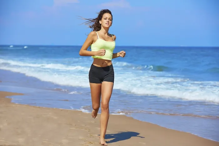 Framed Print : Beautiful brunette girl running in the beach at summer vacations