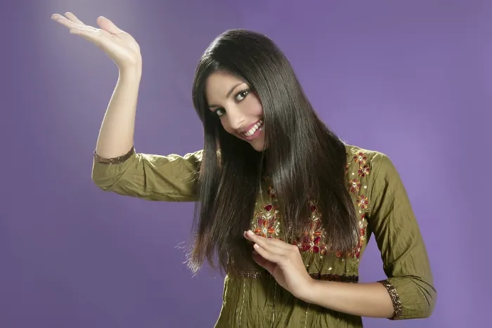 Framed Print : Beautiful indian young brunette woman posing hands on purple background