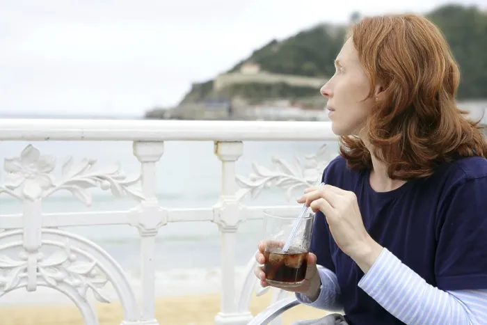 Framed Print : Beautiful redhead woman drinking beverage in La Concha beach San Sebastian