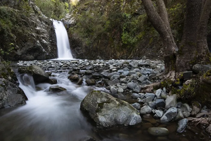 Framed Print : Beautiful Waterfall with stones on the ground in the heart of Machairas forest at Troodos mountains in Cyprus