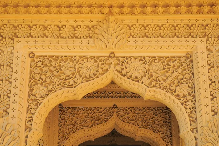 Framed Print : Beautifully carved top of arch door made by sandstones in temple at Amarsagar Lake