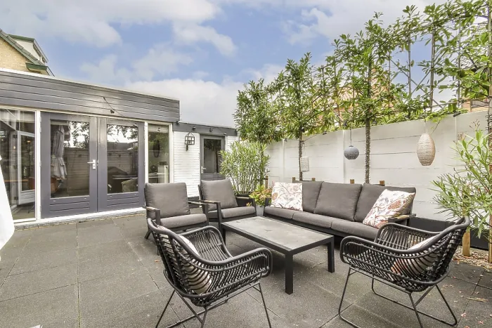 Framed Print : A beautifully designed outdoor patio featuring chic furniture and greenery Framed Print : A beautifully designed outdoor patio featuring chic furniture and greenery