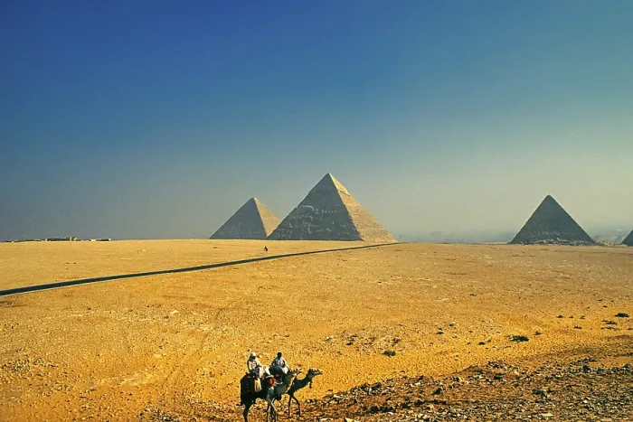 Framed Print : Bedouins on camels, Pyramids of Giza in the back Framed Print : Bedouins on camels, Pyramids of Giza in the back
