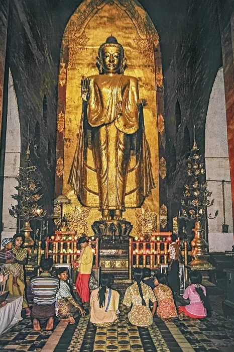 Framed Print : Believers standing in front of a large Buddha in Ananda Temple in Bagan