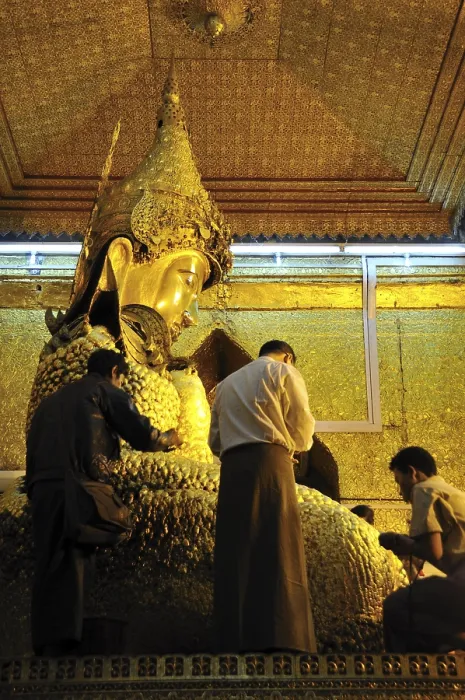 Framed Print : Believers sticking gold foil on a Buddha statue Framed Print : Believers sticking gold foil on a Buddha statue