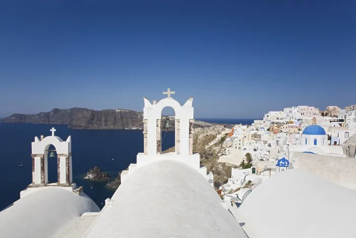 Framed Print : Two bell towers overviewing Oia and the Caldera