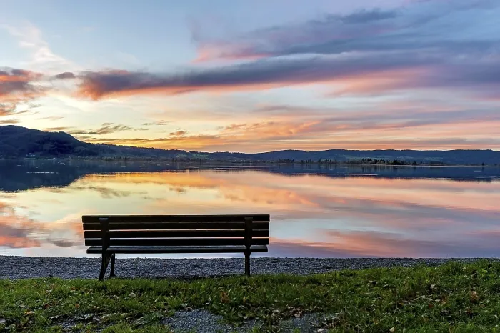 Framed Print : Bench at Lake Kochel, reflection of sun and clouds at sunset