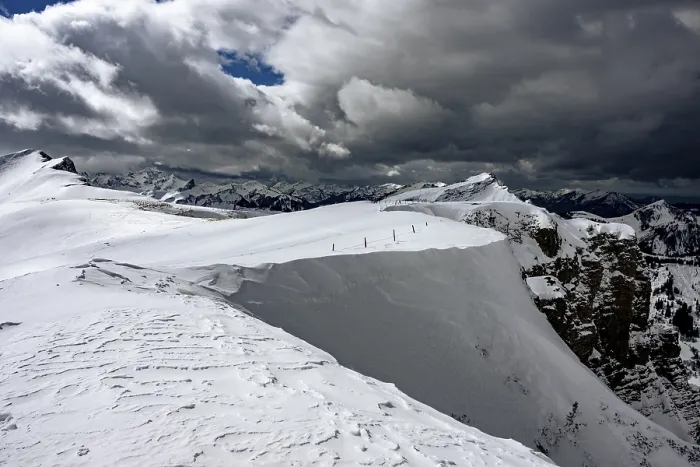 Framed Print : Berlinger Koepfl summit area with snow-covered mountains in the background and dramatic sky