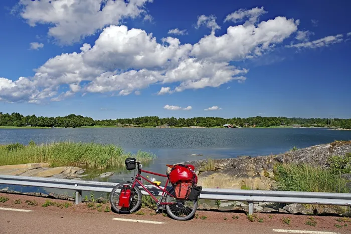 Framed Print : Bicycle with luggage leaning against a guard rail