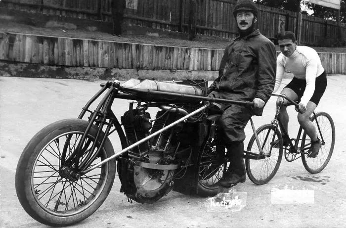 Framed Print : Bicycle rider in tow of a motorcyclist Framed Print : Bicycle rider in tow of a motorcyclist