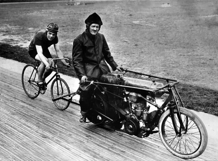 Framed Print : Bicycle rider in tow of a motorcyclist