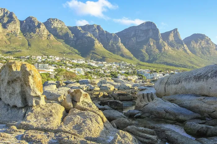 Framed Print : Big rocks in Camps Bay with Table Mountain National Park behind him