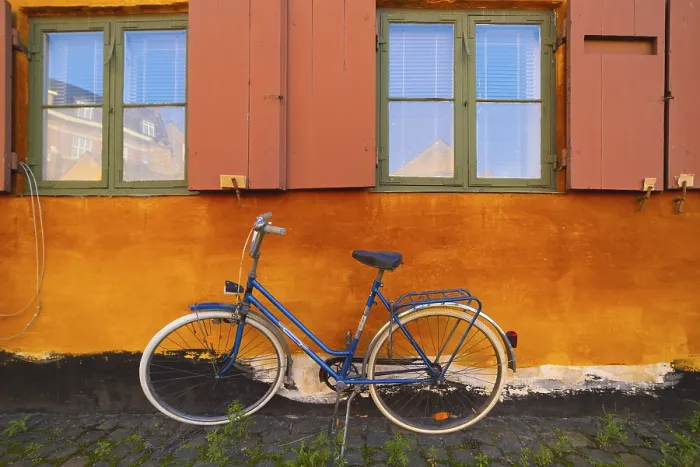 Framed Print : Bike leaning against the orange wall Framed Print : Bike leaning against the orange wall
