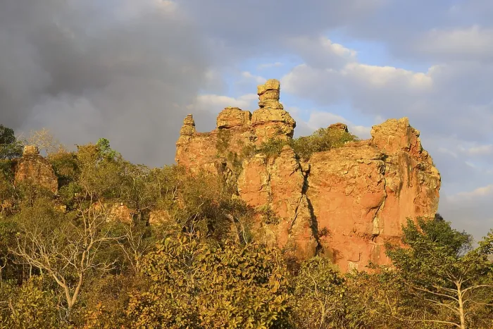 Framed Print : Bizarre rock formation and clouds of smoke during a bushfire