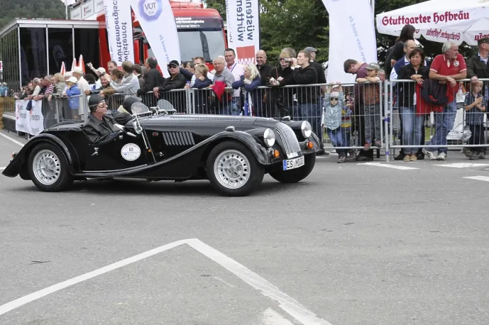 Framed Print : A black convertible classic car at a racing event with spectators in the background Framed Print : A black convertible classic car at a racing event with spectators in the background
