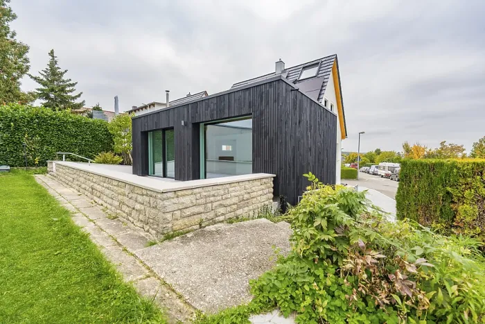 Framed Print : Black, modernly clad extension with large glass areas on lawn