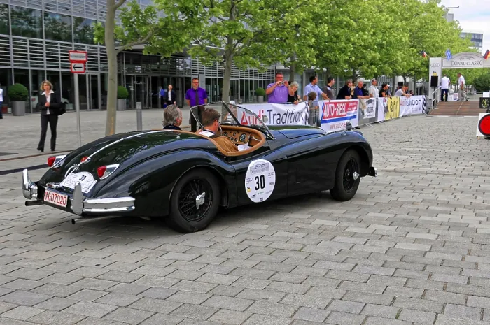 Framed Print : Black vintage convertible on event street with spectators