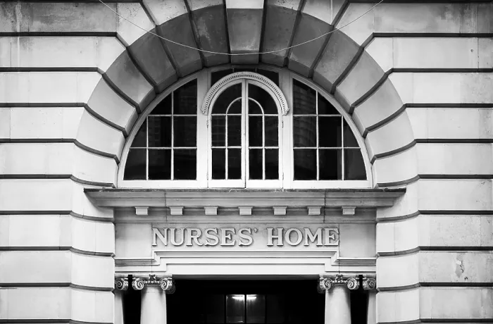 Framed Print : Black and white image of an arched window above the entrance to a historic building in Greater London Framed Print : Black and white image of an arched window above the entrance to a historic building in Greater London
