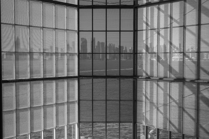 Framed Print : Black and white photo of glass windows reflecting a distant cityscape Framed Print : Black and white photo of glass windows reflecting a distant cityscape