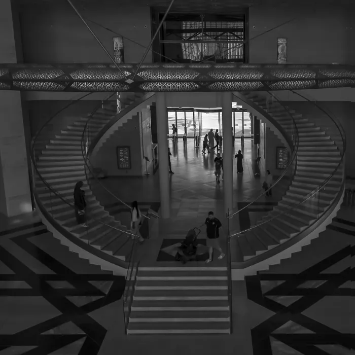 Framed Print : Black and white photo of a modern interior with a spiral staircase and geometric flooring