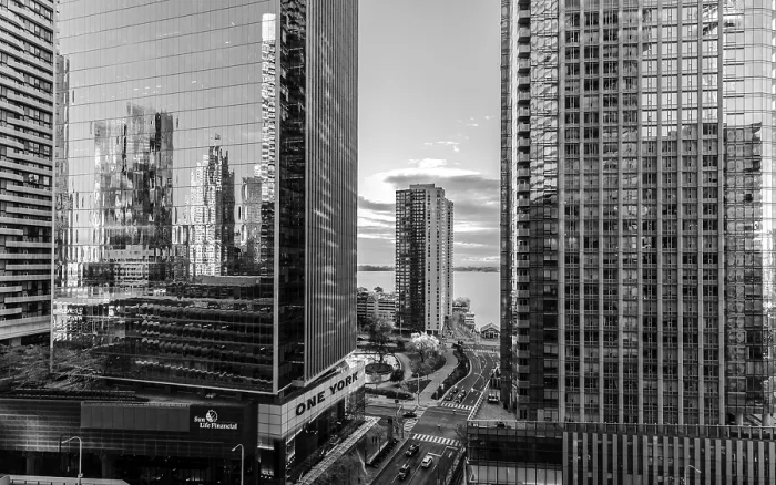 Framed Print : Black and white view of skyscrapers with reflective surfaces and cloudy sky in Toronto