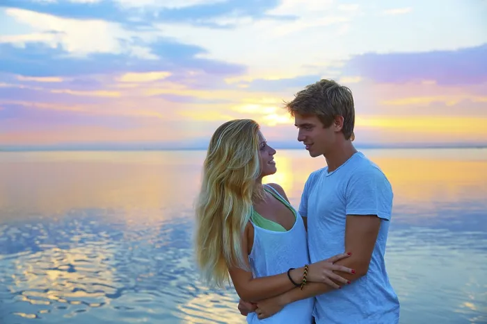Framed Print : Blond young couple hug in sunset sea lake happy together Framed Print : Blond young couple hug in sunset sea lake happy together