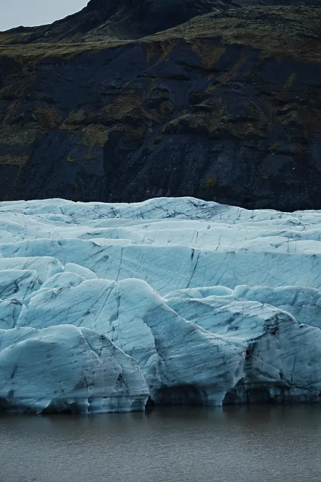 Framed Print : Blue glacier with dark mountainous background