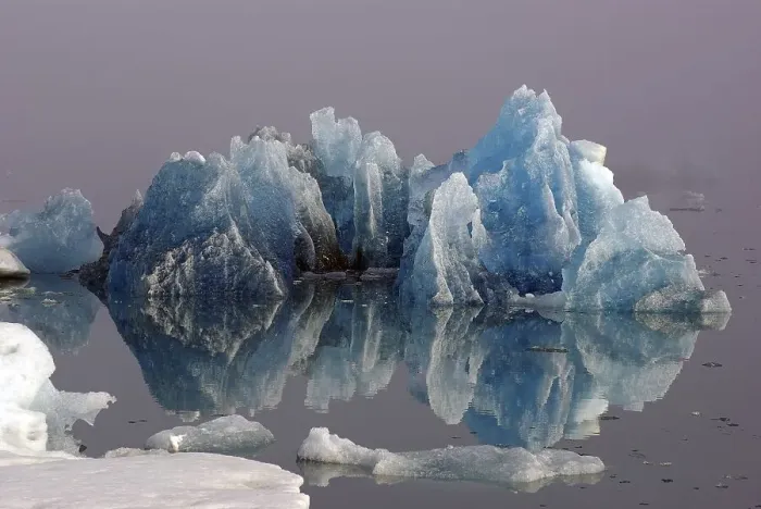 Framed Print : Blue iceberg reflected in the water