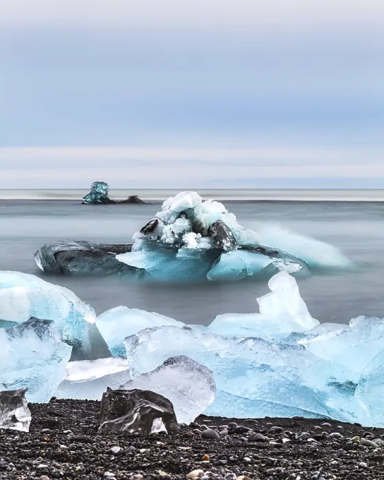 Framed Print : Blue icebergs and chunks floating in a calm ocean scene