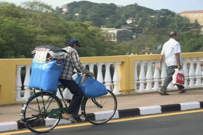 Framed Print : Blue luggage being transported on a bicycle over Old Pato bridge, Yellow bridge on the Mandovi River, Mahatma Gandhi Road, Panjim, Goa, India, Asia