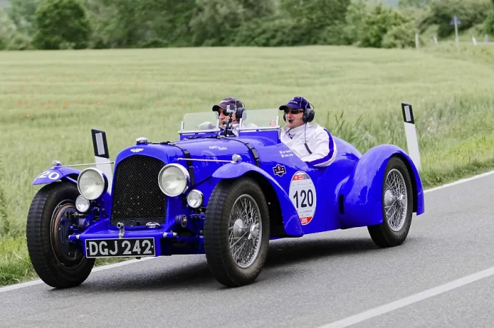 Framed Print : Blue racing gold car with two occupants on a country road Framed Print : Blue racing gold car with two occupants on a country road