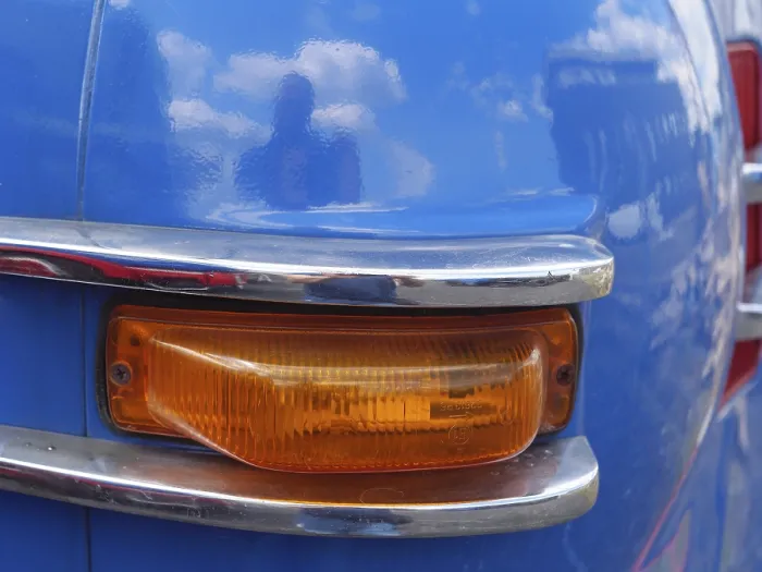 Framed Print : Blue vintage car with orange tail light and chrome accents