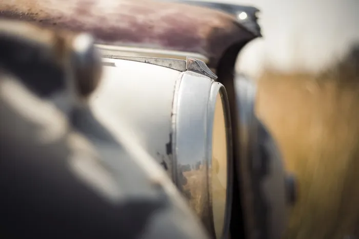 Framed Print : Blurred close-up of an old Jaguar car's headlight and surface with visible rust in rural Huron County