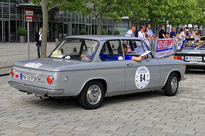 Framed Print : BMW, gray four-door classic car at a car event on cobblestones
