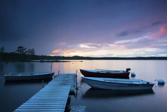 Framed Print : Boats at the jetty at sunset on lake Skaervsjoe