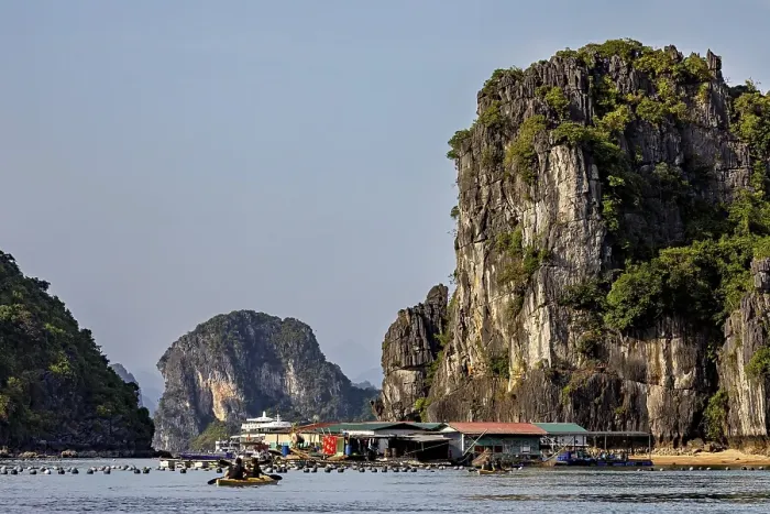 Framed Print : Boats in front of towering limestone cliffs on a clear summer's day