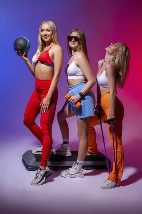 Framed Print : Full body side view of cheerful young women in sportswear smiling Framed Print : Full body side view of cheerful young women in sportswear smiling