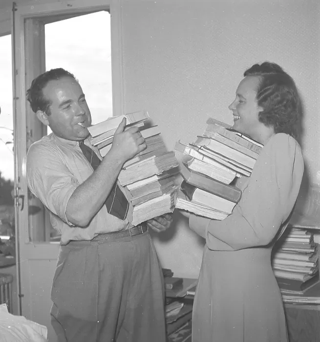 Framed Print : With books in their arms 1945. A man and a woman standing holding a stack of books in their arms. 1945. Kristoffersson ref O139-5