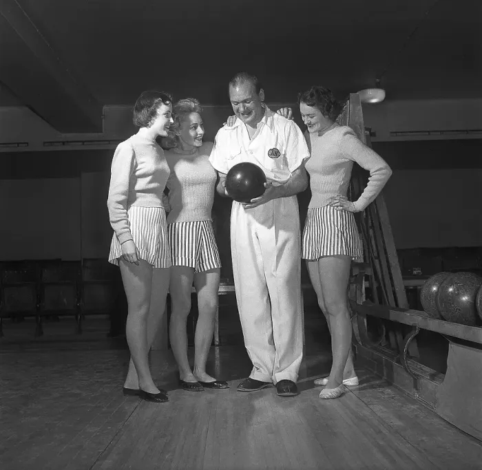 Framed Print : Bowling in the 1950s. A man with three young women in a bowling alley