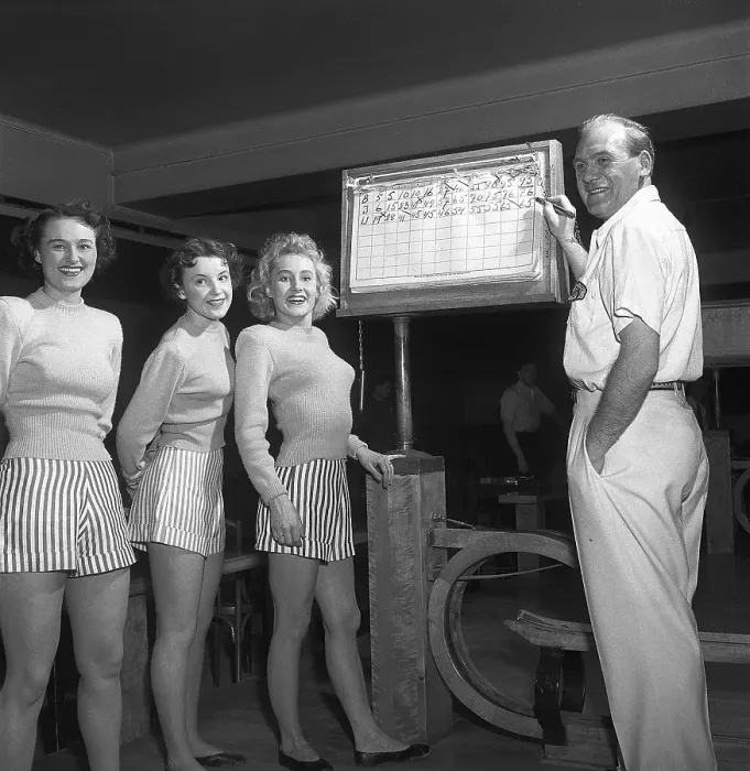 Framed Print : Bowling in the 1950s. A man with three young women in a bowling alley