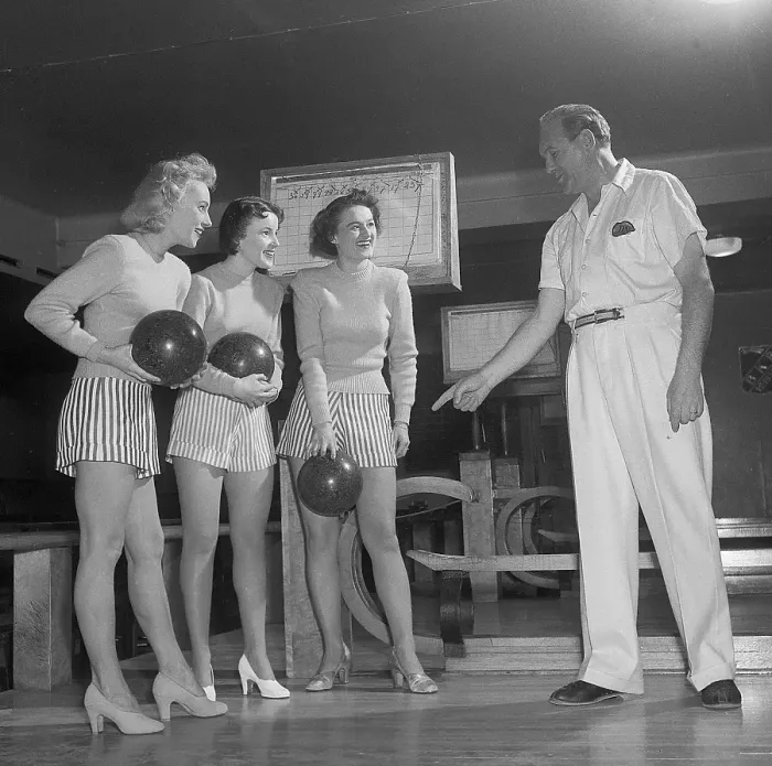 Framed Print : Bowling in the 1950s. A man with three young women in a bowling alley Framed Print : Bowling in the 1950s. A man with three young women in a bowling alley